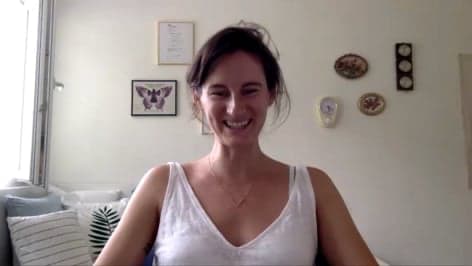 jovana smiling at the camera and wearing a white top