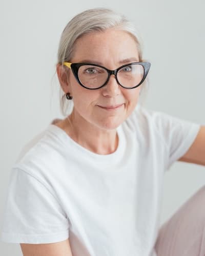 smiling woman with white shirt and glasses