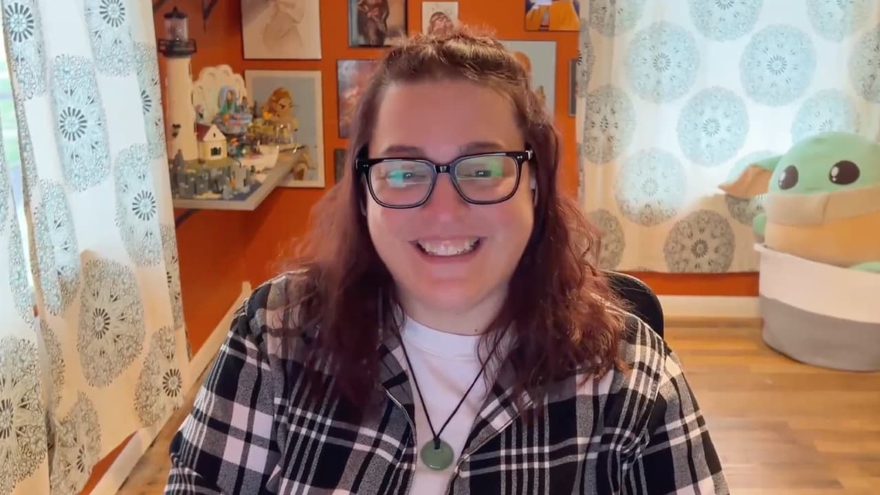 Stephanie is wearing glasses and a plaid shirt, smiling at the camera, and talking about how she ended the fight with insomnia