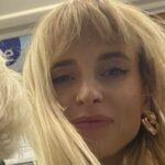 Kyla has long blonde hair and is smiling at the camera